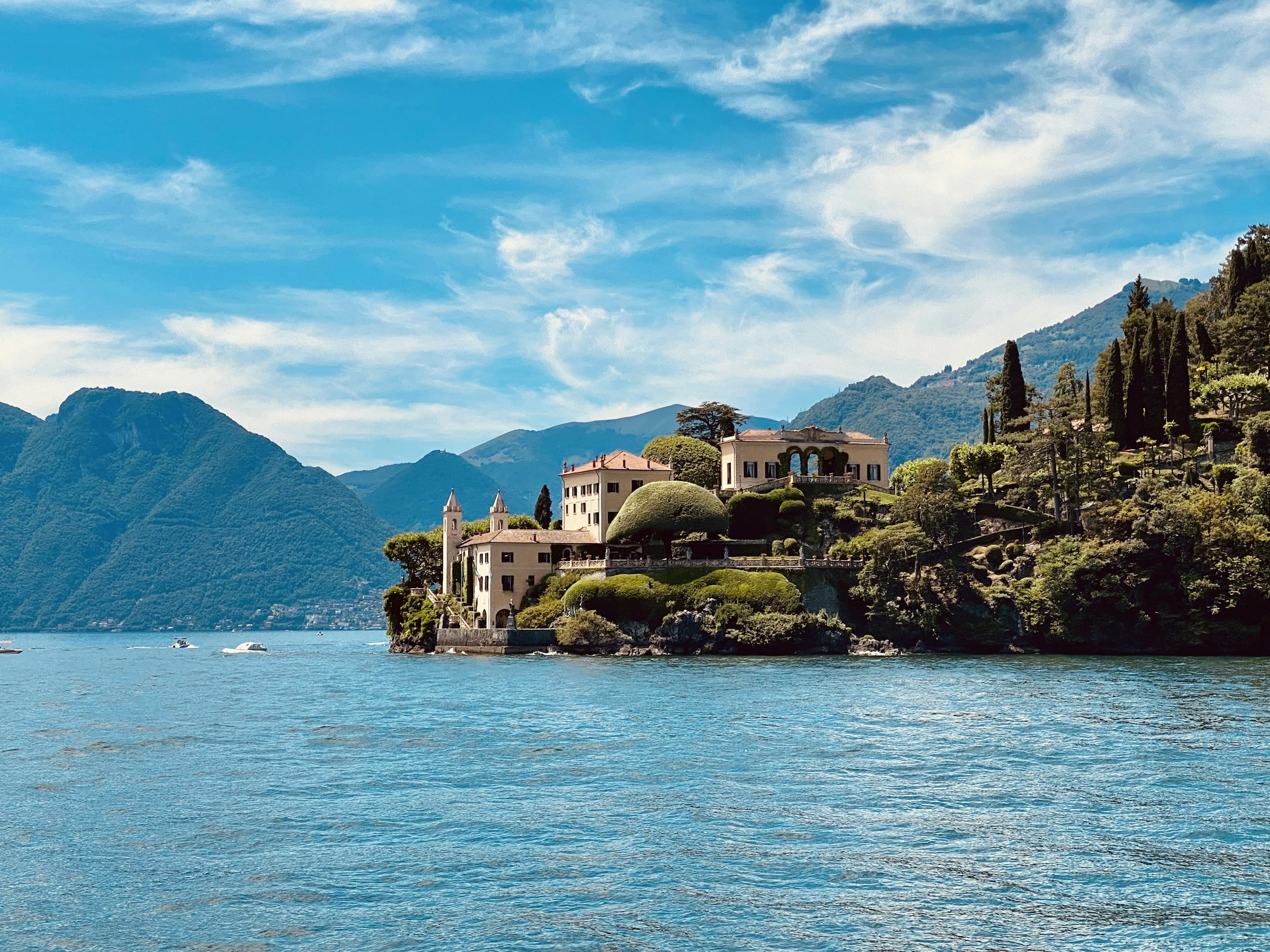 Villa del Balbianello on its promontory over Lake Como, with terraced gardens and mountains behind